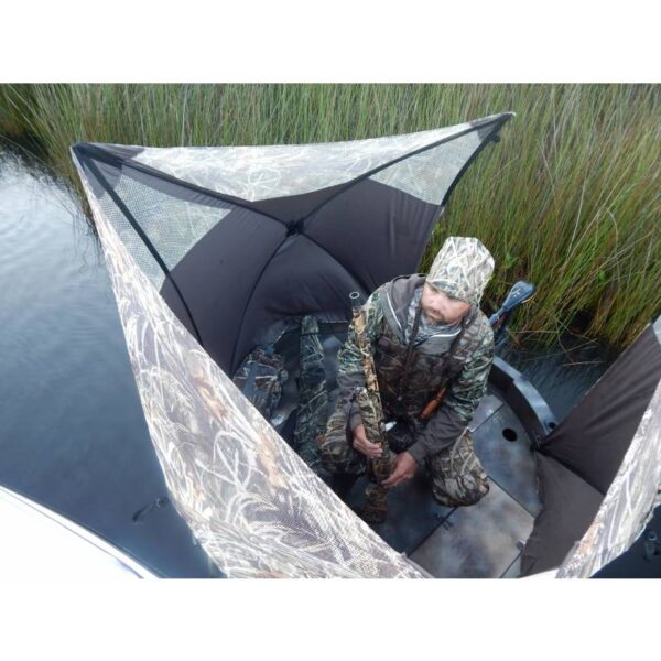 This is a on the water view of the round boat hunting blind by ameristep. Shows hunter with a shotgun inside of this hunting boat.
