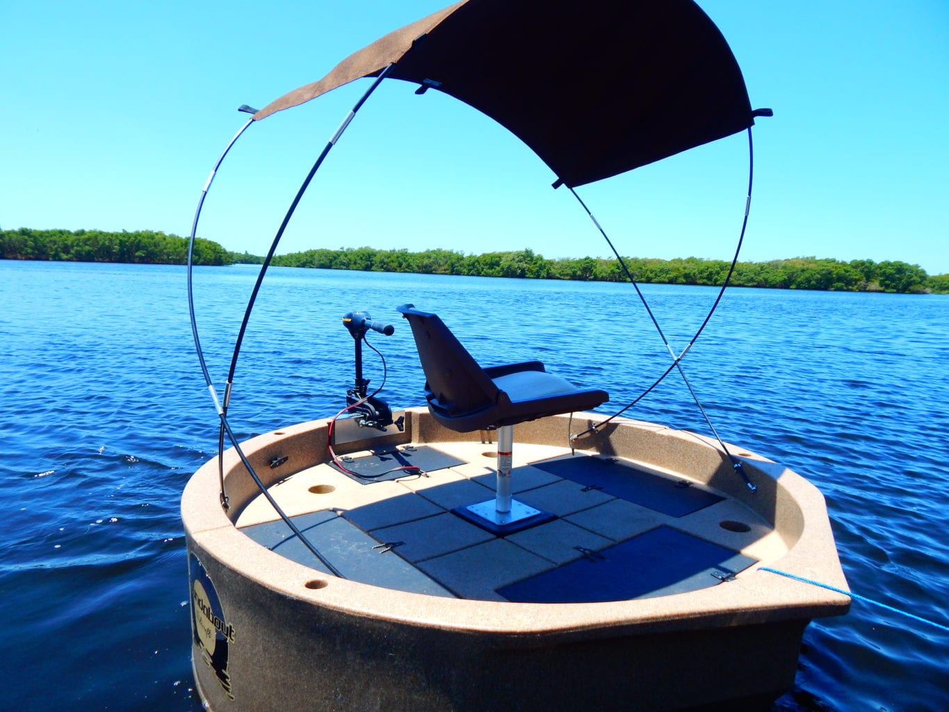 This shows the sunshade installed on a tan colored round boat