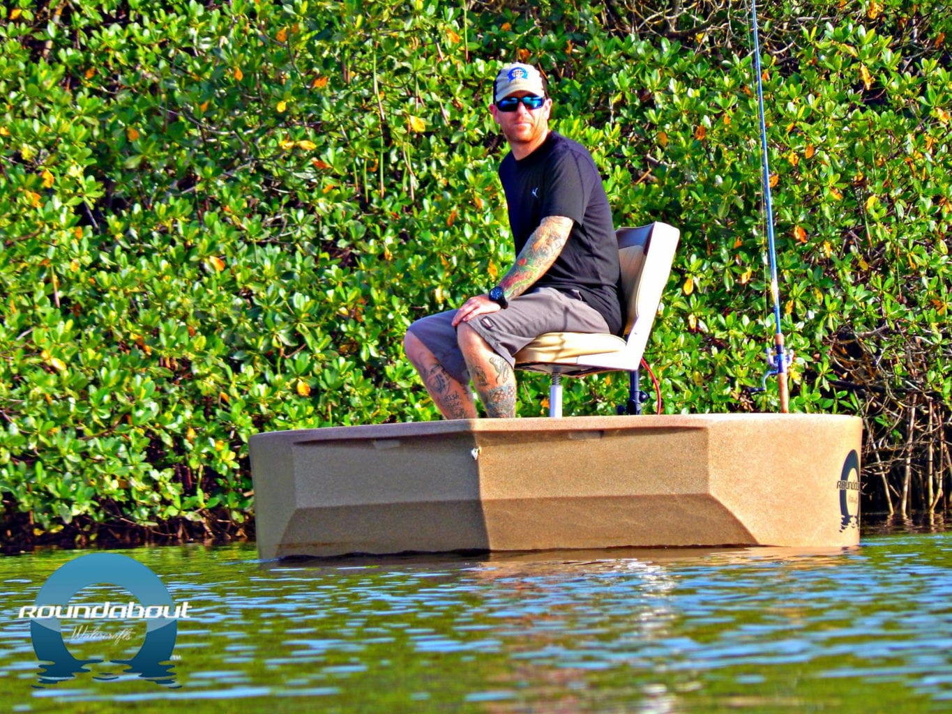 A fisherman driving the Roundabot Watercrafts round boat away from the shoreline with an electric trolling motor.